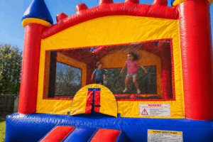kids jumping in colorful bounce house