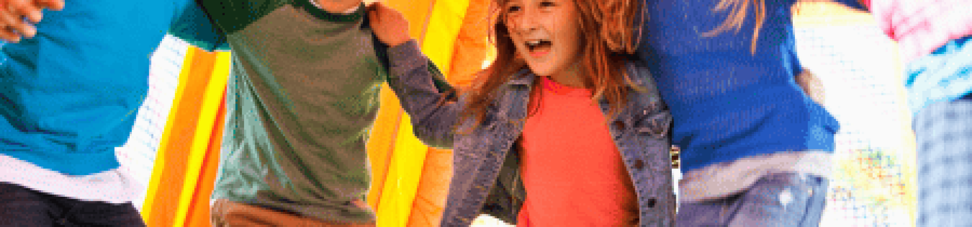 Kids laughing and jumping inside a colorful bounce house